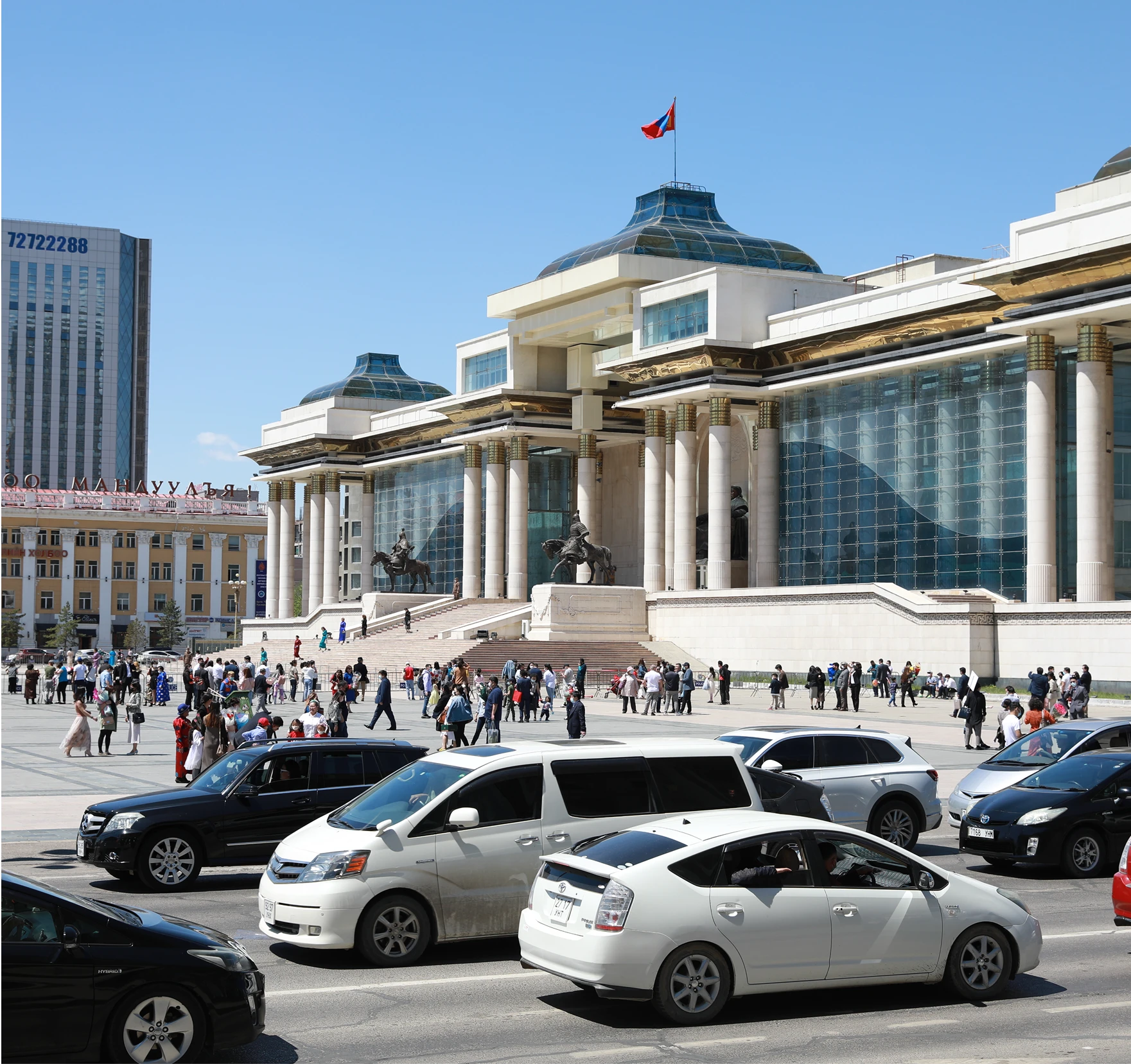 Mongolian parliament building in the background with cars on a road