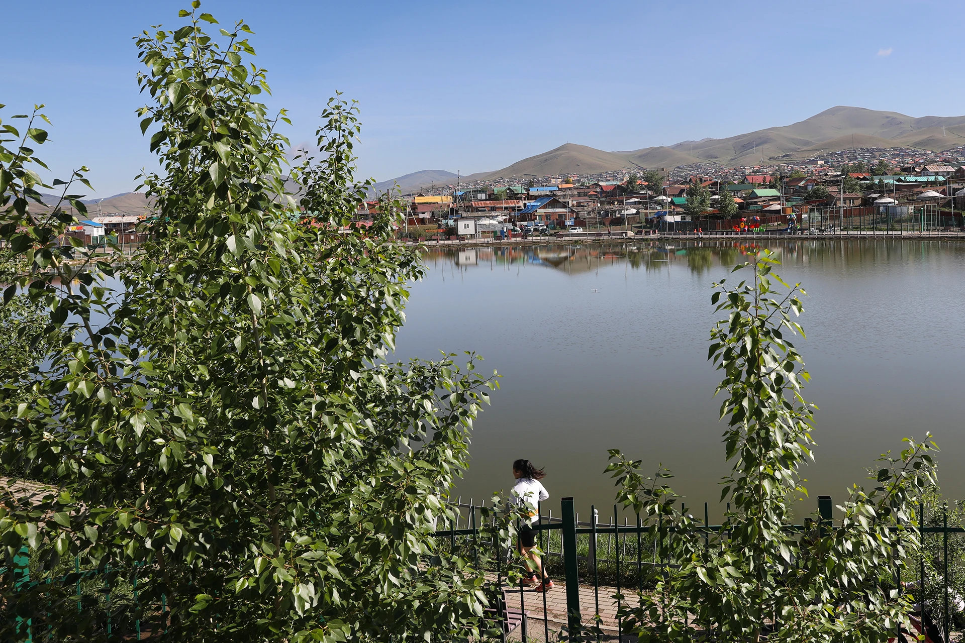 Mongolian neighborhood in the distance with water in the forground.