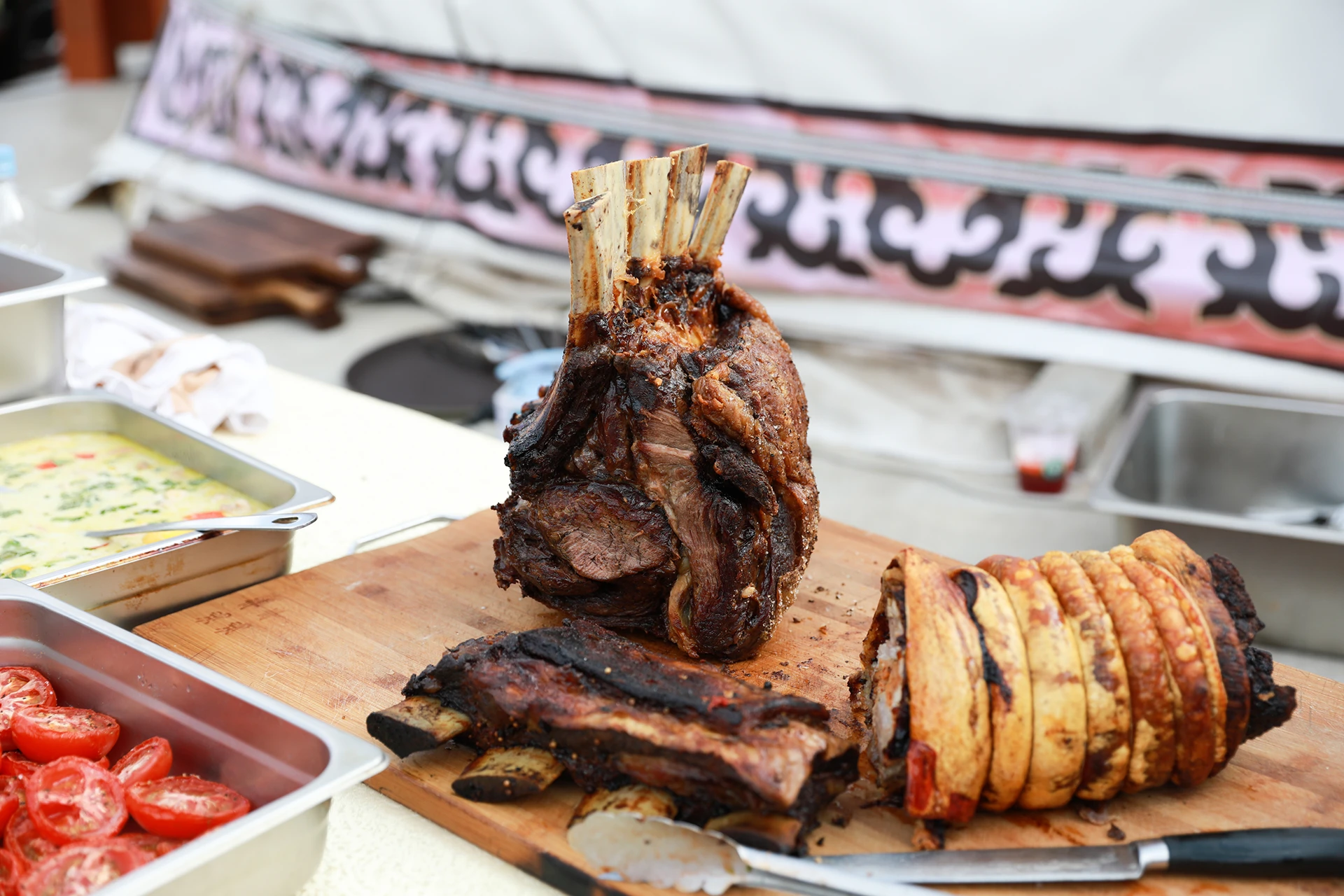 Cooked beef ribs and a knife on a cutting board